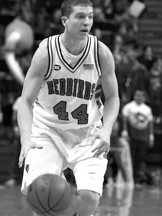 Brett Gillan dribbling a basketball in an Illinois State Redbirds number 44 jersey